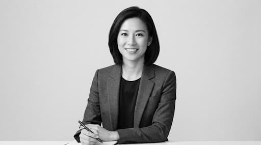 High-end editorial studio portrait of Sophia Chen, East Asian female principal full stack software engineer, sharp monochrome styling, minimalist composition, soft direct studio key lighting, stark neutral background
