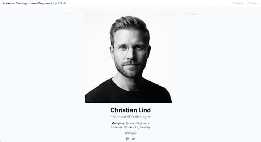 Monochrome studio portrait of Christian Lind, Scandinavian male technical SEO strategist, wearing minimal rimless eyewear, stark light-and-shadow portrait style, pristine white negative space.